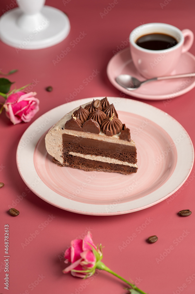 Coffee mousse cake with dark chocolate , sweet dessert over pink background. Piece of cake on a pink plate. Coffee mousse cake with dark chocolate , sweet dessert over pink background. Piece of cake on a pink plate.