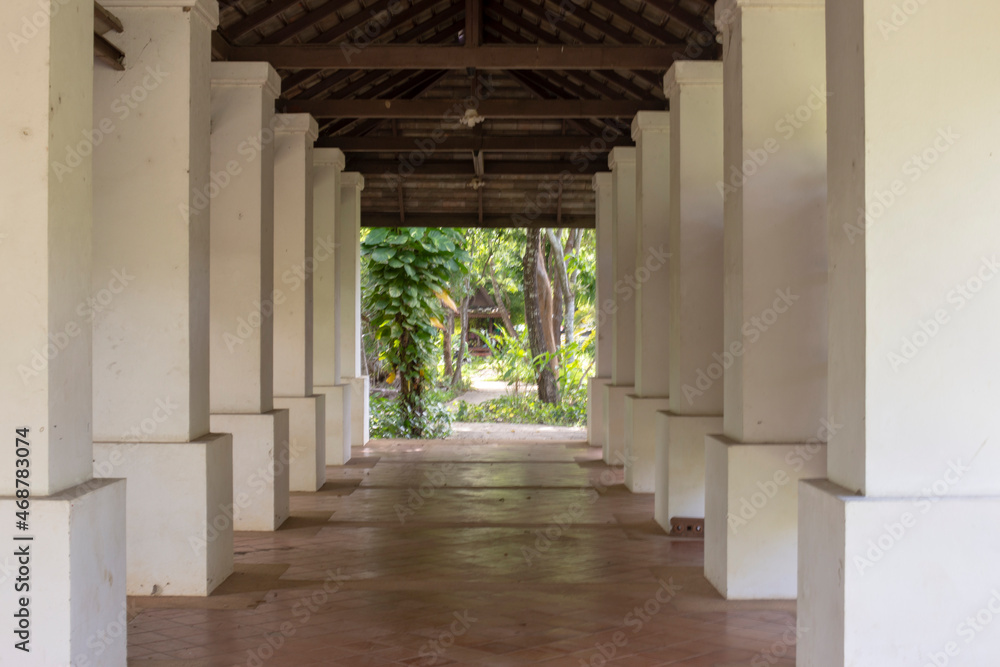 The entrance arch with large white columns. Blurred background. The entrance arch with large white columns. Blurred background.