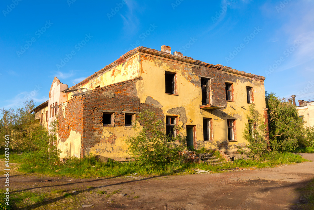 A two-storey abandoned house on a deserted street in an abandoned settlement Severny, Russia