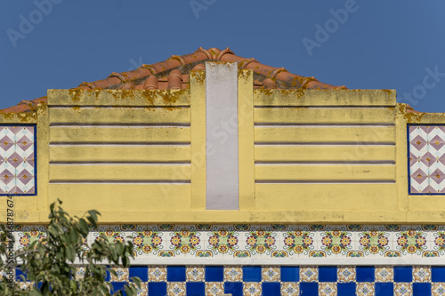 art deco pediment and Azulejos panels on facade of an art deco style house in Odiáxere, Algarve, Portugal