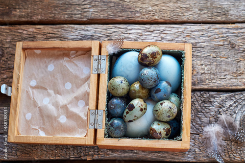 Easter quail eggs in a wooden box