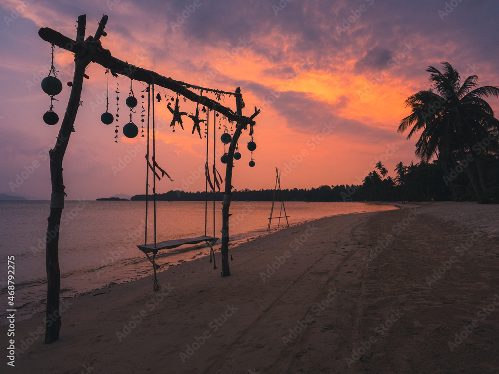 Scenic view of peaceful tropical island beach with relax swing against sunset cloudy twilight sky. Koh Mak Island, Trat, Thailand. - obrazy, fototapety, plakaty 