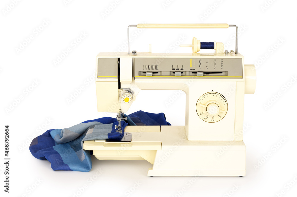 Piece of fabric on a sewing machine isolated on completely white background. Contains clipping path Piece of fabric on a sewing machine isolated on completely white background. Contains clipping path