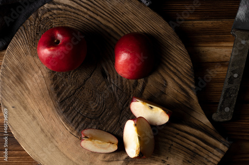 Fresh red apples on wooden table. On wooden background.