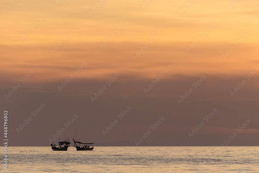 Two boats on the sea during sunset time