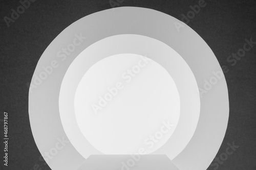 White and dark grey abstract scene with podium  circles tunnel or arches with perspective  light as stage template in minimal geometric style for presentation products  advertising  design.