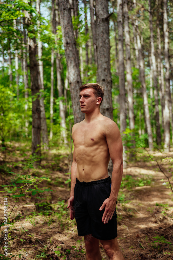 Young man doing stretching exercise at mountain Young man doing stretching exercise at mountain