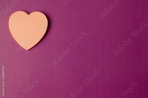 Pink heart on a lilac background with copy space. Valentine's day and wedding concept