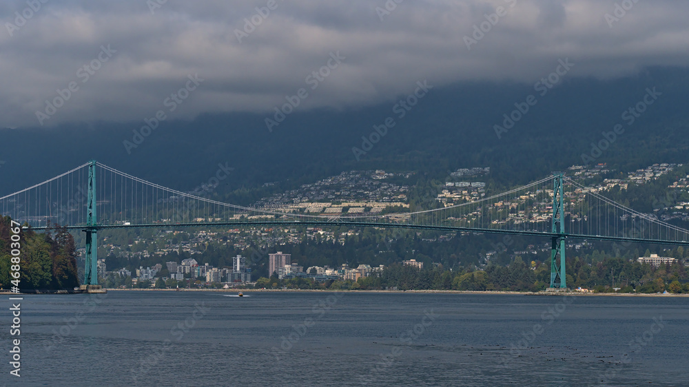 View of Lions Gate Bridge (First Narrows Bridge) crossing Burrard Inlet in Vancouver, British Columbia, Canada with the city of West Vancouver.