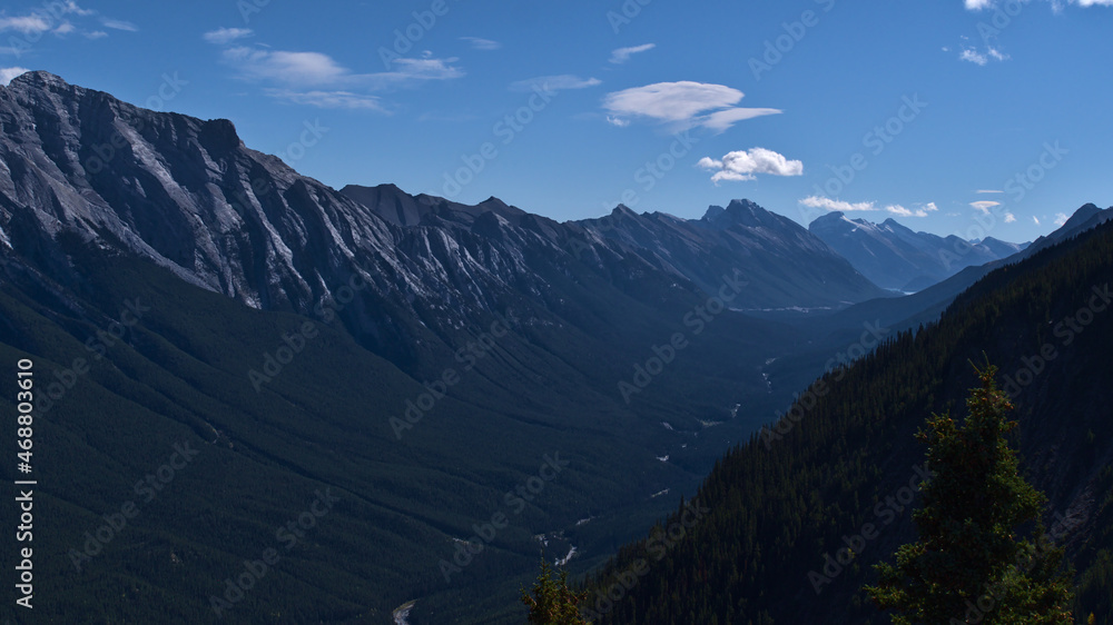 Beautiful view of the rugged Rocky Mountains near Banff, Banff National Park, Alberta, Canada with Rundle Group and Spray River valley and forests.
