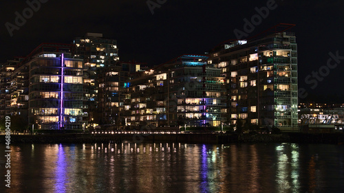 Beautiful night view of illuminated modern apartment buildings on the shore of Vancouver North, British Columbia, Canada near The Shipyards. © Timon