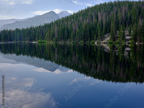 Pine trees and mountains reflected in the calm waters of Bear lake in Rocky Mountain National Park Colorado © Jorge Moro