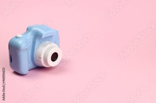 plastic toy camera for children on a pink background. Copy space for text