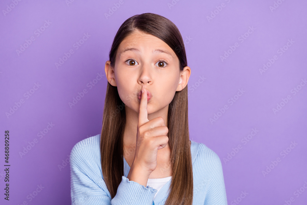 Photo of silence brunette small girl finger mouth wear blue shirt isolated on violet color background