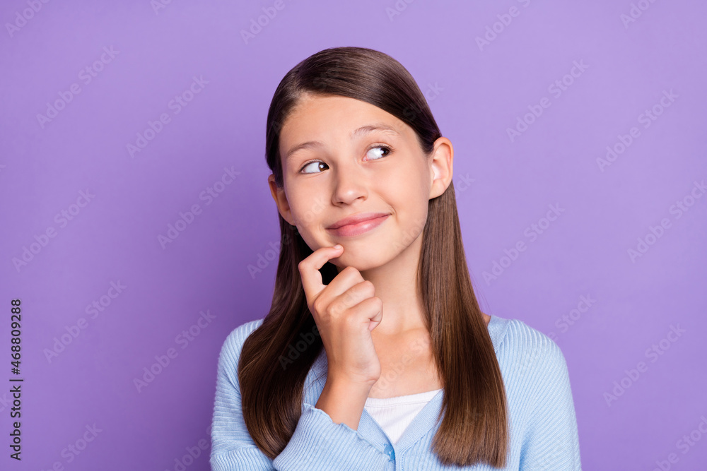 Photo of cute brunette little girl finger face look empty space wear blue shirt isolated on violet color background Photo of cute brunette little girl finger face look empty space wear blue shirt isolated on violet color background