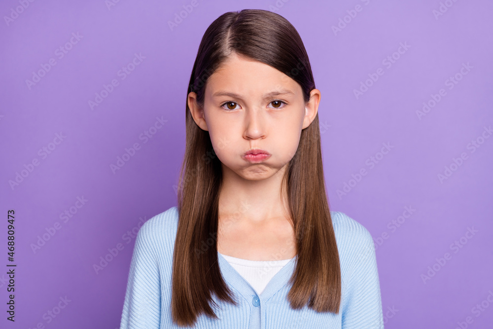 Photo of nice brunette little girl pouted lips wear blue shirt isolated on violet color background Photo of nice brunette little girl pouted lips wear blue shirt isolated on violet color background