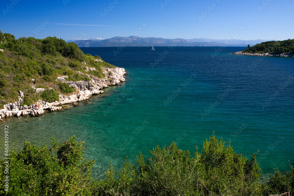 The deep, sheltered and beautiful bay of Mongonissi (otherwise known as Limeniskos Ozia or Port Ozias Bay), which separates Mongonissi from the rest of the island of Paxos, Ionian Islands, Greece The deep, sheltered and beautiful bay of Mongonissi (otherwise known as Limeniskos Ozia or Port Ozias Bay), which separates Mongonissi from the rest of the island of Paxos, Ionian Islands, Greece