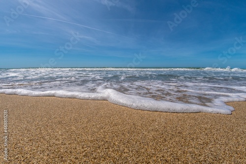 Sea with waves in the foreground on the shoreline