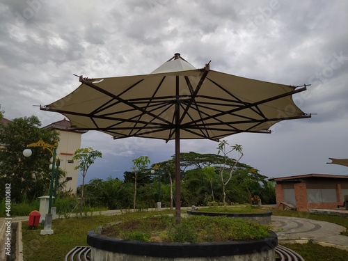 garden bench with umbrella-shaped roof © light stock