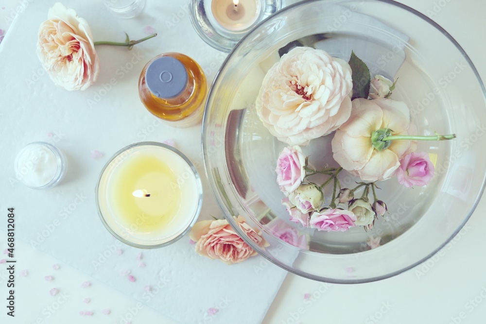 Fresh roses, burning candles, ingredients for skin care on a light background, top view, healthy lifestyle concept, relaxation, home cosmetics, aromatherapy, alternative medicine Fresh roses, burning candles, ingredients for skin care on a light background, top view, healthy lifestyle concept, relaxation, home cosmetics, aromatherapy, alternative medicine