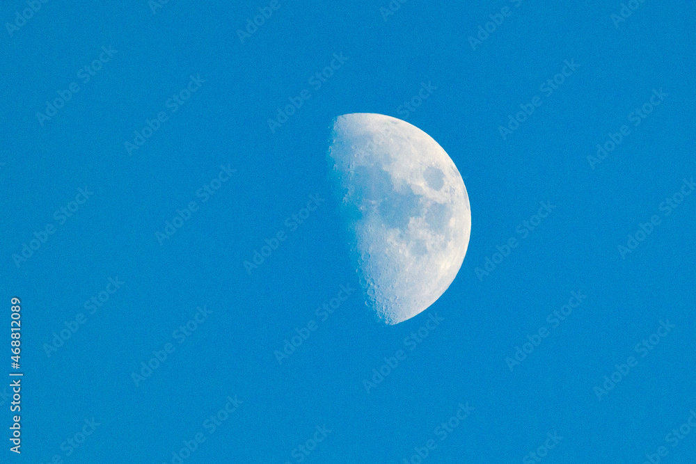 Crescent moon. The crescent moon during the day next to the completely