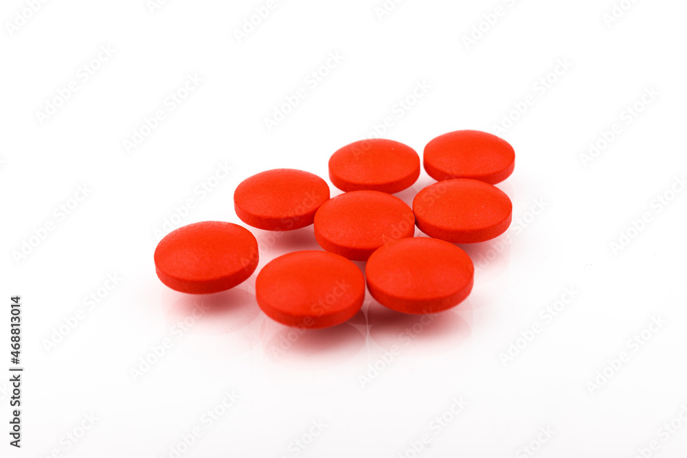 Red pills on a white background, isolated. Pharmacy. Treatment. Red pills on a white background, isolated. Pharmacy. Treatment.
