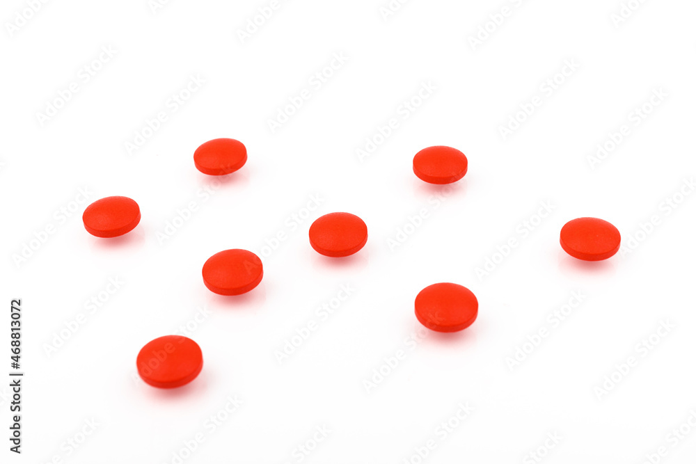 Fototapeta premium Red pills on a white background, isolated. Pharmacy. Treatment.