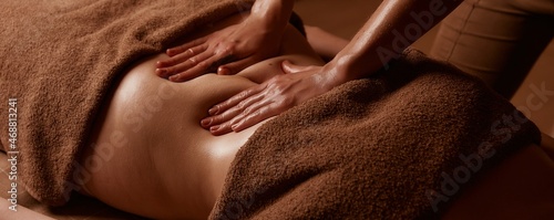 Cellulite removal procedures. Female hands massage the girl's abdomen. Taking care of your body in a saved salon