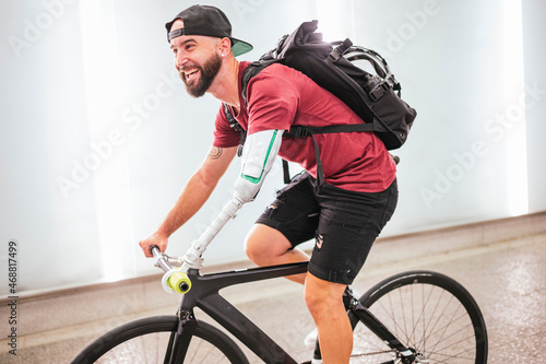 Man with bionic arm riding bike in city photo