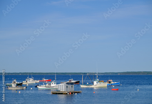 Anchored colorful red white and blue Lobster Boats on a perfect summer day sitting at harbor © Jorge Moro