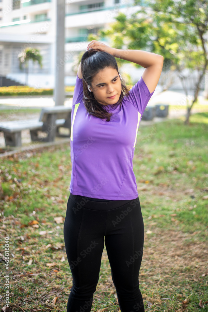 Beautiful and athletic Hispanic woman exercising at a city park Beautiful and athletic Hispanic woman exercising at a city park