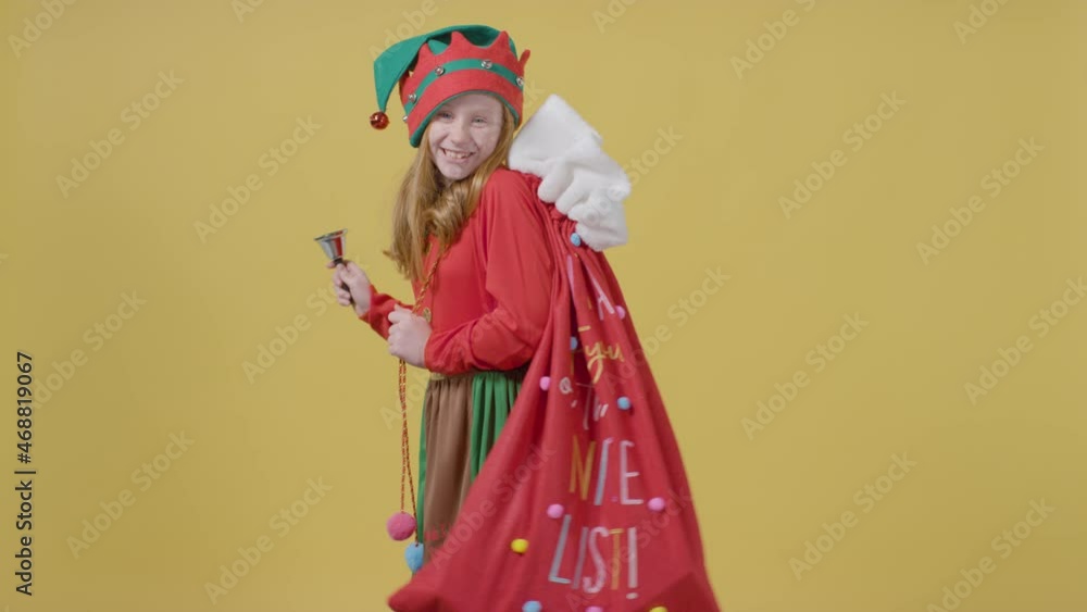 Young Girl Walking Holding Christmas Sack and Bell Young Girl Walking Holding Christmas Sack and Bell