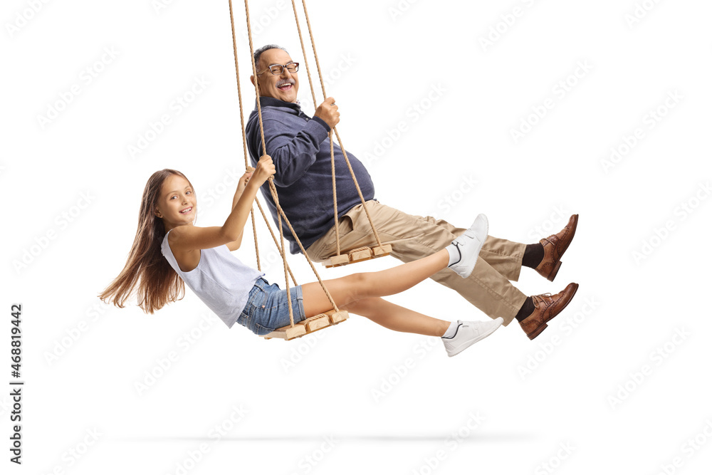 Side shot of a grandfather and granddaughter swinging on wooden swings Side shot of a grandfather and granddaughter swinging on wooden swings