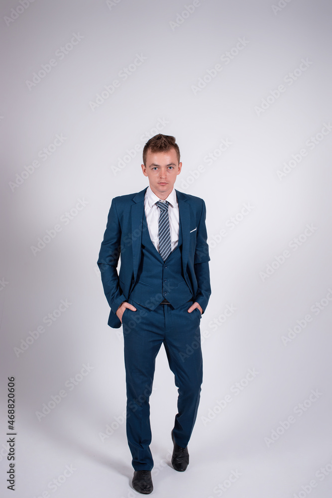 Elegant man in a business suit on a gray background. Elegant man in a business suit on a gray background.