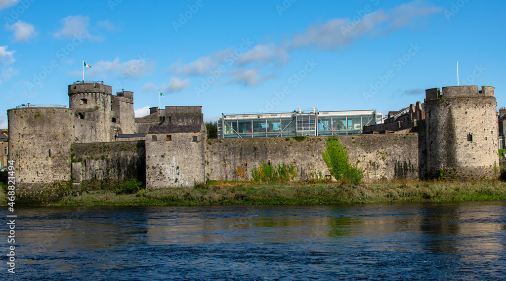 View of King John's Castle, Limerick, Ireland, overlooking the glass segment, for tourists, on the side of the Shannon River