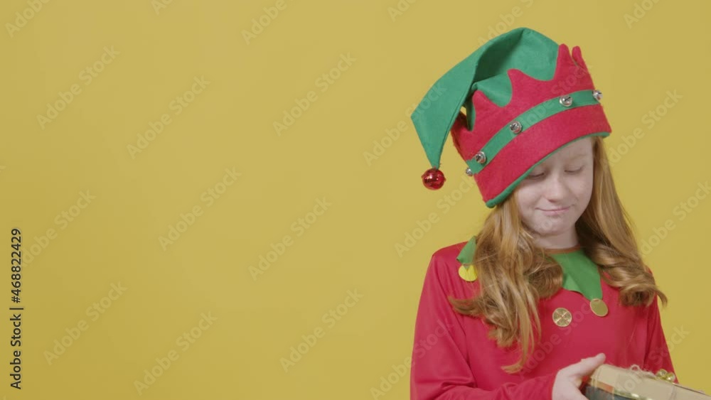 Curious Girl Shaking Christmas Present with Copy Space Curious Girl Shaking Christmas Present with Copy Space