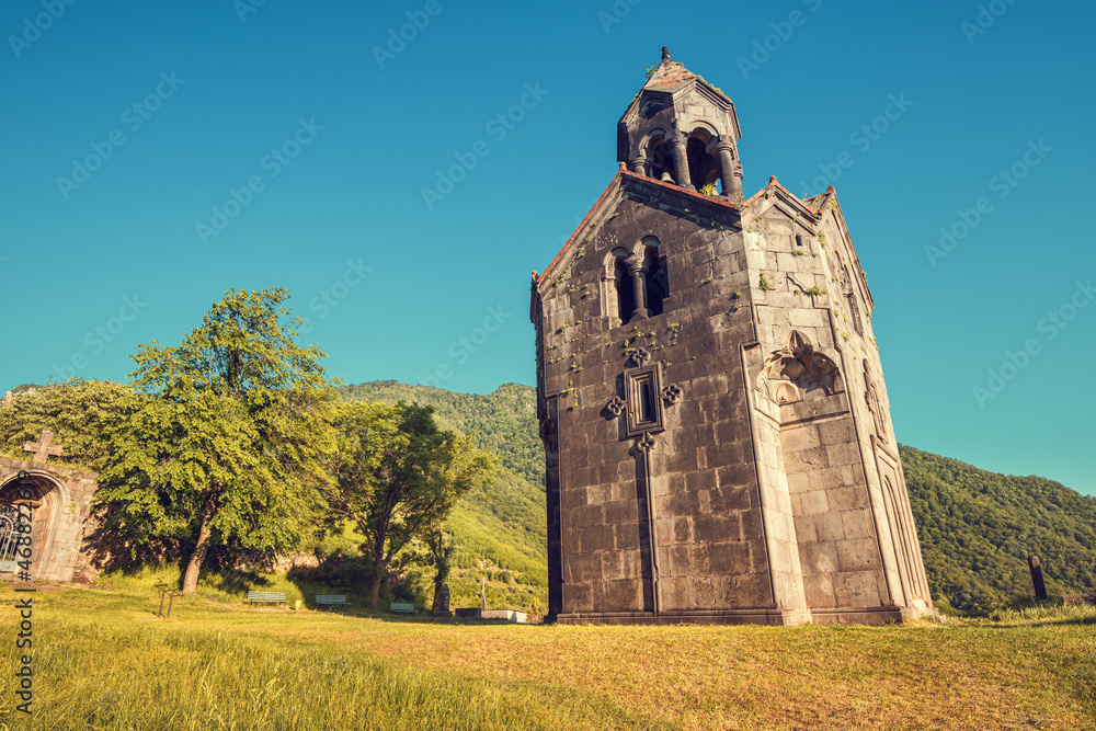 Fototapeta premium The chapel and bell tower stand alone on the territory of the Haghpat Monastery in Armenia. Sightseeing and pilgrimage concept