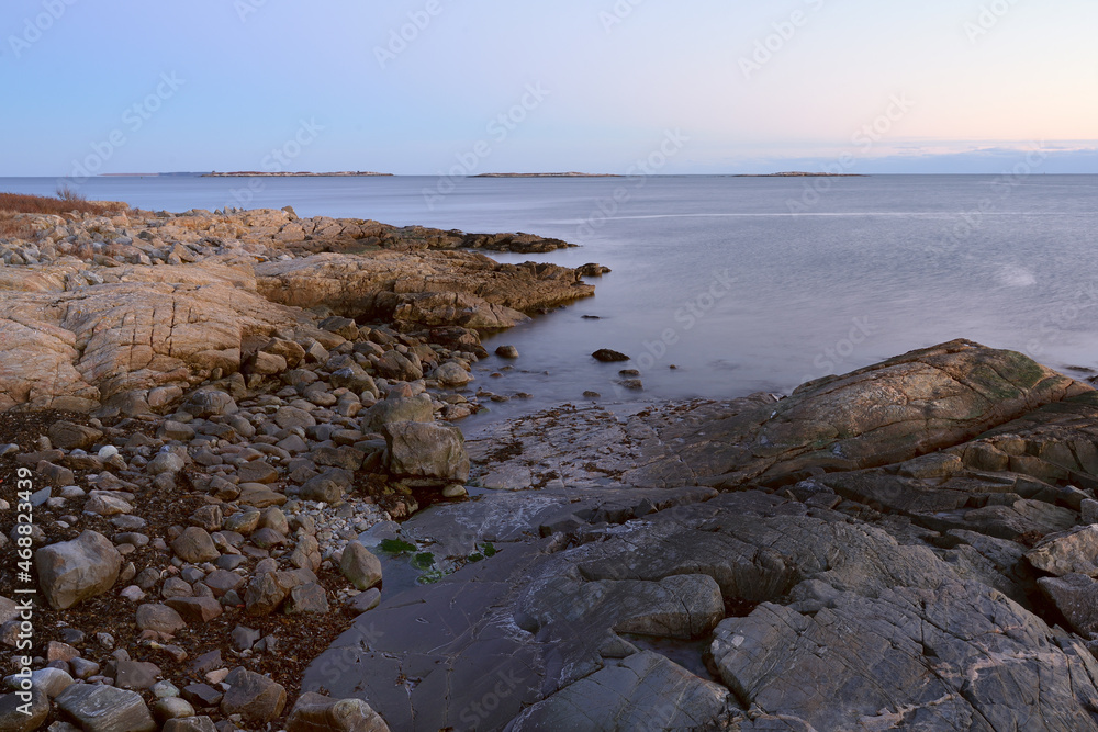 Exposed rocks and barnacle at low tide on St. George Island at sundown with a slow exposure