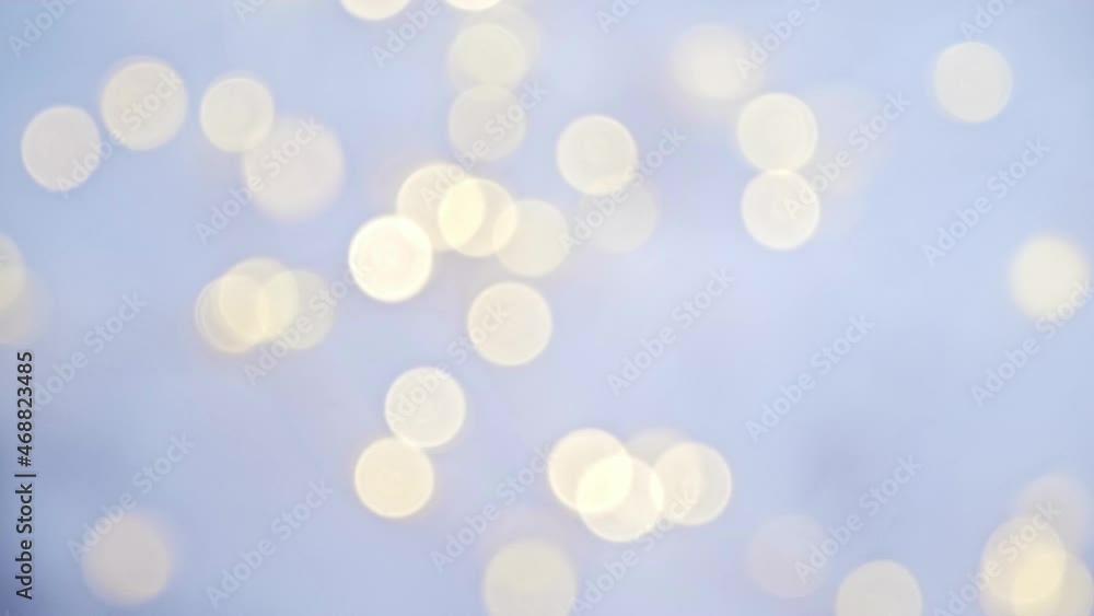 Glowing bokeh flickering on a blue background. Christmas light, magic, glitter, celebration. A universal beautiful background with blur in gentle colors for websites, designers. Glowing bokeh flickering on a blue background. Christmas light, magic, glitter, celebration. A universal beautiful background with blur in gentle colors for websites, designers.