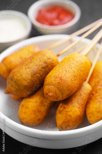 Corn dogs cooked with sausage and dough, selective focus photo