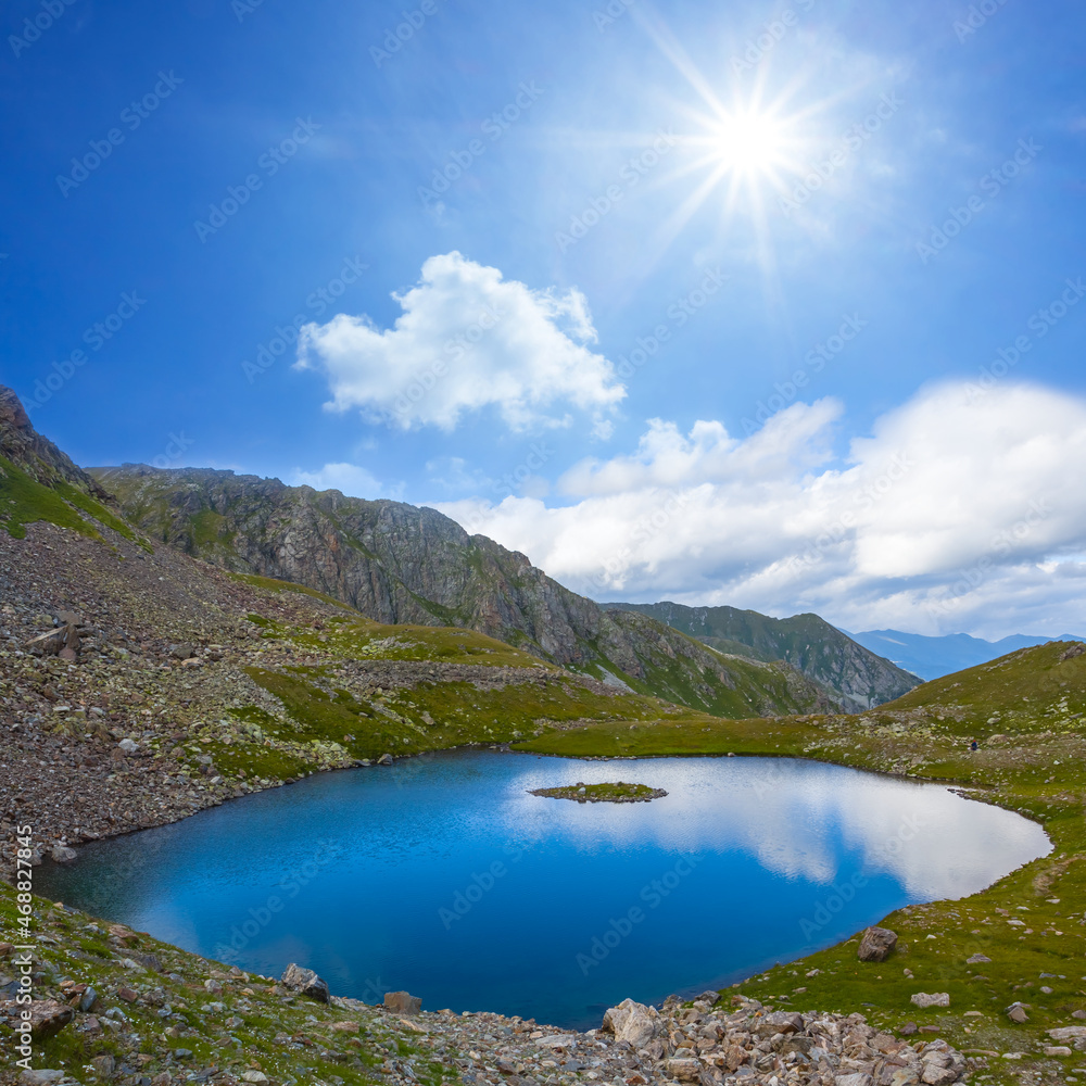 small blue lake in mountain valley at the sunny day