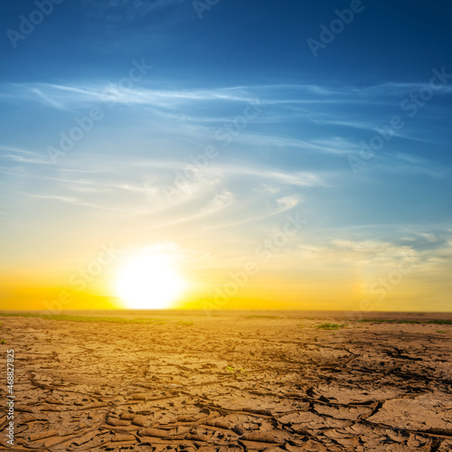 dry wide cracked saline land at the sunset, natural calamity scene