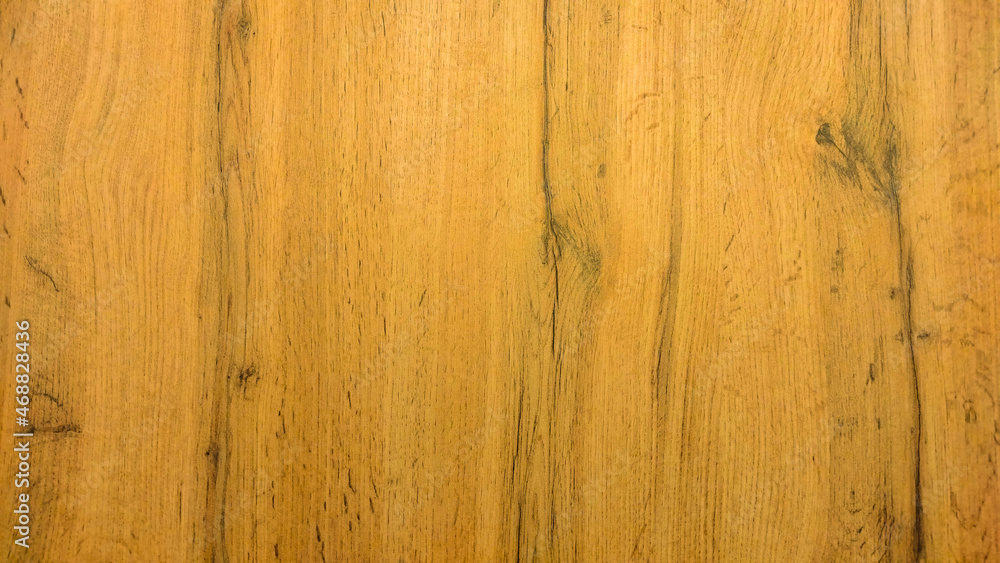 Obraz premium The wooden texture is yellow with vertical lines. Wooden surface.
