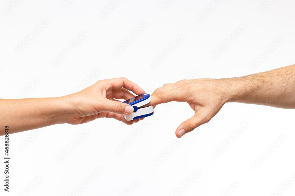 Lung function monitor concept with doctor in latex gloves device that measures blood oxygen level called pulse oximeter and patient finger isolated on white background with clipping path cutout Lung function monitor concept with doctor in latex gloves device that measures blood oxygen level called pulse oximeter and patient finger isolated on white background with clipping path cutout