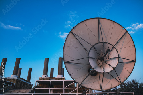 A huge horn against the background of factory pipes. The factory is calling. Abandoned Kazantip Beach photo