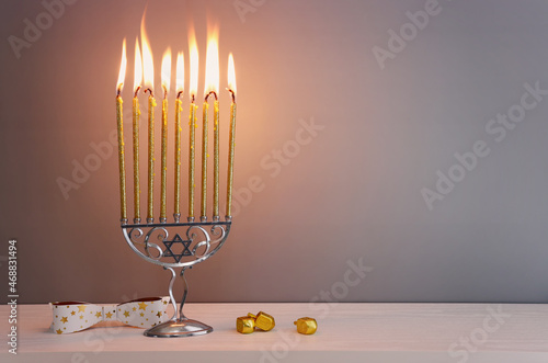 Religion image of jewish holiday Hanukkah background of menorah (traditional candelabra), spinning tops with letters that mean, a great miracle happened here