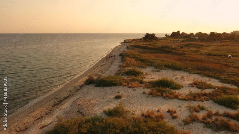 4k aerial top view above sunset sand beach sea. Greece seaside village small houses bay Thracian sea wild beach white sand. aerial view drone above Greece in day sunset summer sea 4K quality footage 4k aerial top view above sunset sand beach sea. Greece seaside village small houses bay Thracian sea wild beach white sand. aerial view drone above Greece in day sunset summer sea 4K quality footage