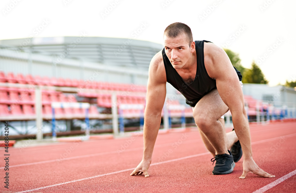 Millennial athletic muscular sportsman doing push ups in a fitness park outdoors - Focused male doing workout on the floor - Strength and bodybuilding concept