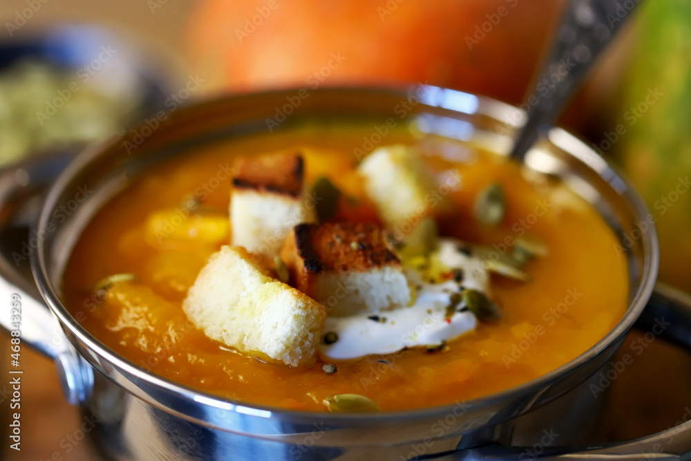Delicious pumpkin soup in a saucepan.