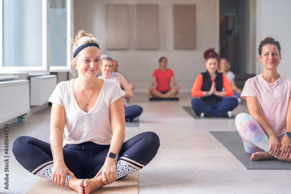 Women smiling and having fun during a pilates/yoga class. Women smiling and having fun during a pilates/yoga class.
